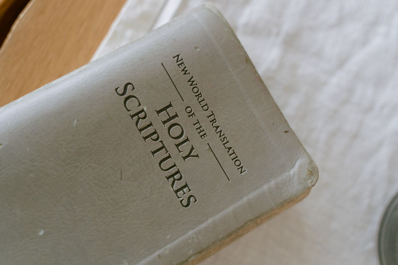 A close-up photo of the New World Translation of the Holy Scriptures on a table.